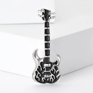 Detail of guitar brooch with silver metal finish and black flame rock pattern texture