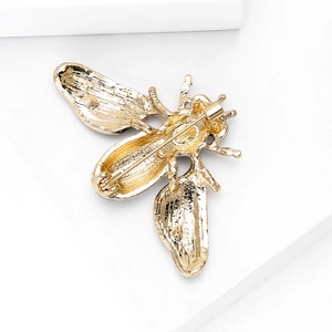 Back view of gold bee brooch showing secure pin fastener on geometric pedestal