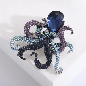 Vintage octopus brooch pin with multi-colored rhinestones and deep blue crystal gem