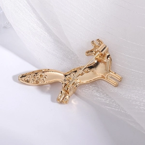 Detailed back view of a golden fox brooch showing secure safety pin and hollowed tail craft