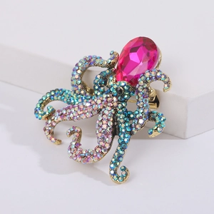 Detailed macro view of retro gold octopus brooch featuring colorful rhinestones and pink gem