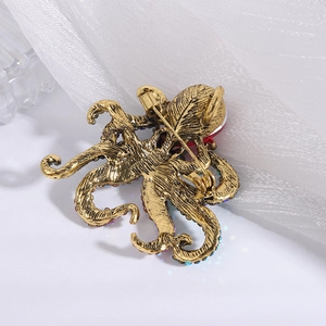 Macro shot of octopus brooch back showing the metal pin fastener on vintage gold finish