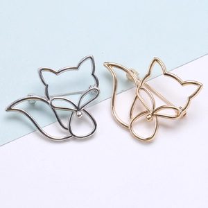 Broches de renard évidées dorées et argentées pour tailleurs de femme sur fond bleu et blanc