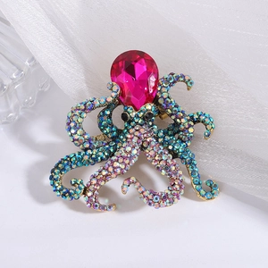 Close-up of octopus brooch with colorful rhinestones and pink teardrop gemstone detail