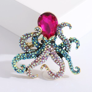 Octopus brooch with colorful rhinestones and pink pear-shaped stone on white background