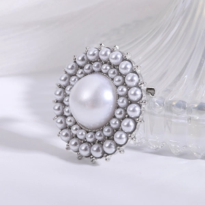 Elegant vintage multilayer pearl brooch with a large center pearl and silver metal base