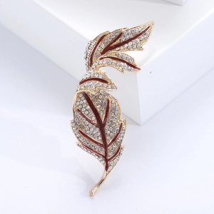 Vintage maple leaf brooch with sparkling diamonds and red enamel on a gold metal base
