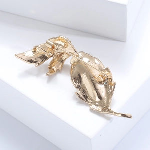 Detailed back view of gold maple leaf brooch with secure metal pin and vein texture