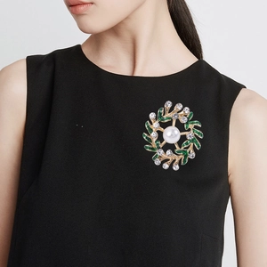 Fashionable floral wreath brooch with green enamel leaves, crystals and a center pearl