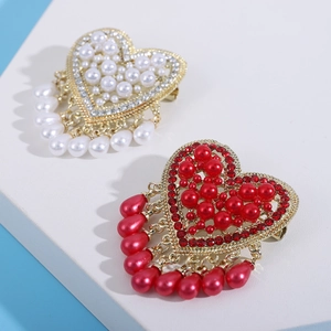 Detail of luxury heart brooches with pearls, rhinestones and elegant water drop tassels