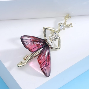 Detail of ballerina brooch with rhinestone bodice and purple butterfly wing skirt