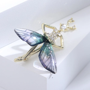 Macro detail of fairy brooch with gold alloy frame and crystal inlaid dragonfly wings