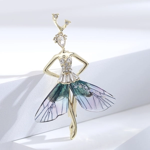 Macro detail of fairy brooch with emerald gradient wings and sparkling cubic zirconia