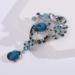 Broche vintage con diamantes de imitación azules en forma de pera y diseño floral