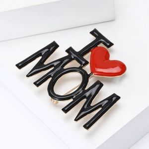 Detailed view of alloy MOM letter brooch with red heart enamel on a white block stand