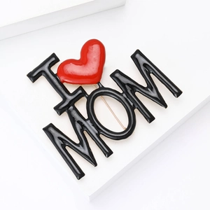 Detail view of I Love MOM alloy brooch with red heart enamel on white stairs