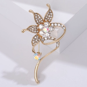 Detailed close-up of sparkling floral brooch with crystals and gold-tone petals