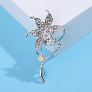 Detailed macro view of silver flower brooch with sparkling rhinestones and AB crystals