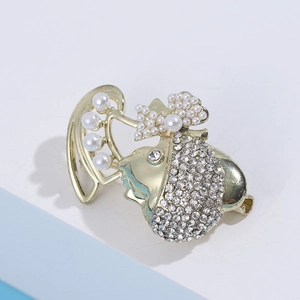 Detail of creative golden girl brooch with inlaid rhinestones and white pearls