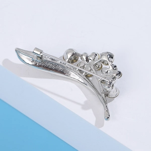 Detail view of the silver leaf brooch back showing secure pin clasp and metal craftsmanship