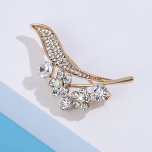 Detailed view of the gold-tone floral brooch with shimmering crystal rhinestones
