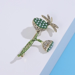 Detail of dragonfly and lotus seed pod brooch with green enamel and pearls