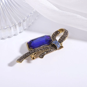 Detailed macro view of vintage alloy brooch with large deep blue gemstone and crystals