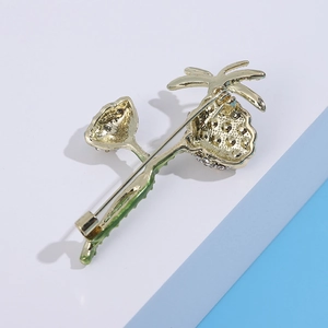 Detailed back view of lotus brooch showing gold metal pin and green enamel stem texture