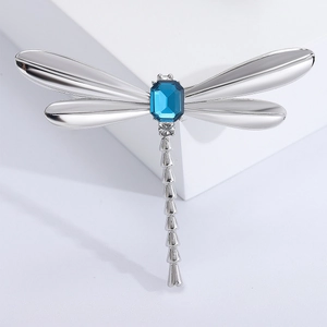 Vintage dragonfly brooch with silver alloy wings and a rectangular blue gemstone center