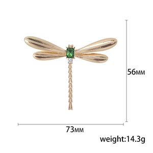 Vintage dragonfly brooch in gold alloy with green gemstone and white zircon accents