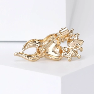 Golden crown tooth brooch back view showing secure safety pin clasp and metallic finish