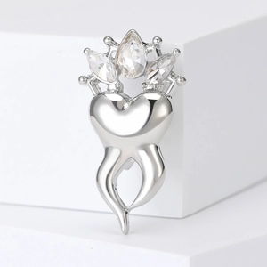 Fashionable crown tooth brooch with rhinestones and heart design on white background
