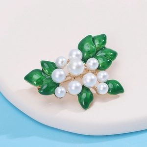 Elegant floral alloy brooch with green enamel leaves and faux pearls on gold base