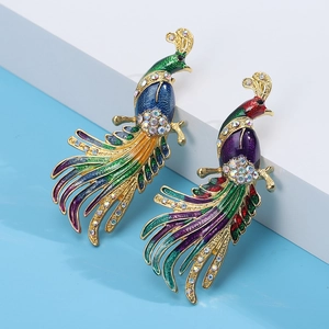 Detailed macro view of colorful enamel peacock brooches with sparkling crystal accents