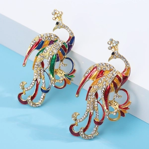 Detailed close-up of peacock brooch with colorful enamel and sparkling rhinestones