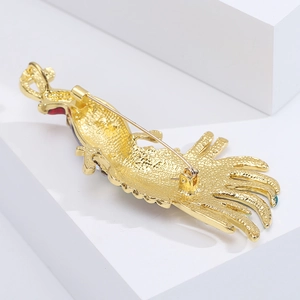 Detail view of the back of peacock feather brooch with matte golden texture and pin clasp