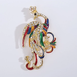 Close-up of vintage phoenix brooch with colorful enamel details and white rhinestones