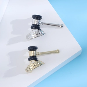 Fashion alloy gavel brooches in gold and silver finishes with black enamel detailing