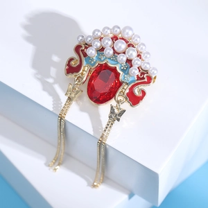 Detail of Chinese Peking Opera headdress brooch with red gemstone and tassel
