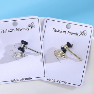 Detail shot of gavel earrings in gold and silver finish on fashion jewelry display cards
