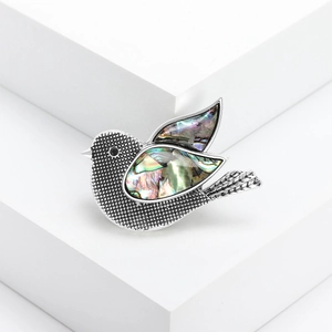 Vintage dove brooch with natural abalone shell inlay and silver retro textured finish