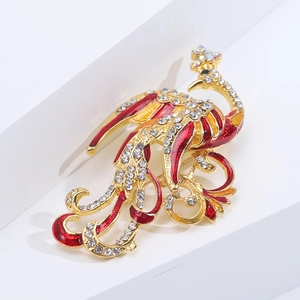 Detailed view of vintage phoenix brooch with red enamel and shimmering rhinestones