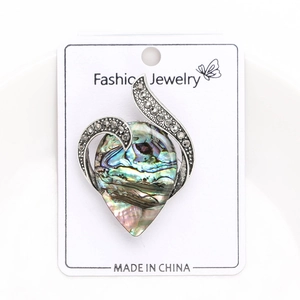 Detail of teardrop abalone shell brooch with silver wavy frame and marcasite stones