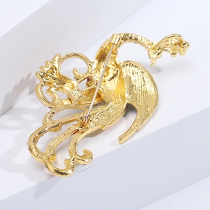 Detailed back view of gold-plated phoenix brooch showing safety pin clasp and hollow craftsmanship
