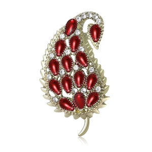 Elegant paisley leaf brooch in gold finish with red pear enamel and white crystal rhinestones