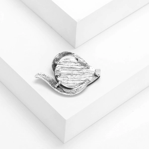 Back view of silver alloy teardrop brooch with secure pin buckle on white background