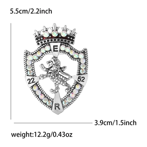 Macro shot of antique silver lion shield brooch with crown and rhinestone details