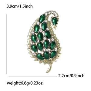 Golden paisley leaf brooch with green crystals and white rhinestones, 3.9cm length