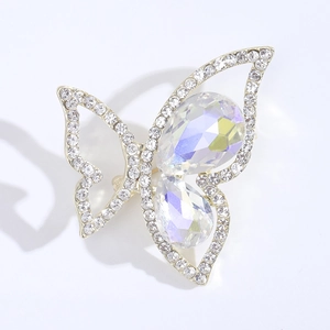 Detailed macro view of a gold butterfly brooch featuring rhinestones and crystal wings