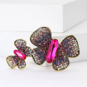 Exquisite vintage butterfly brooch set with purple crystals on elegant white steps